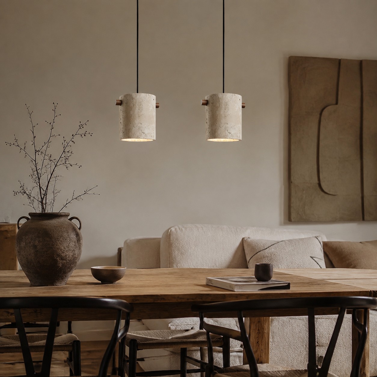 Two travertine pendants over a dining table