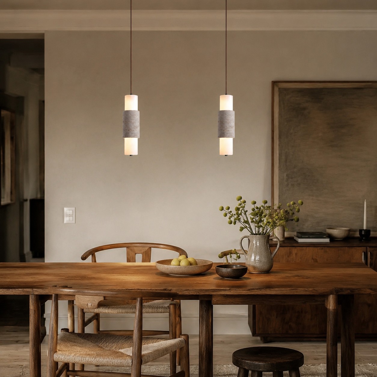 Dining scene with travertine cylinder pendants above the table